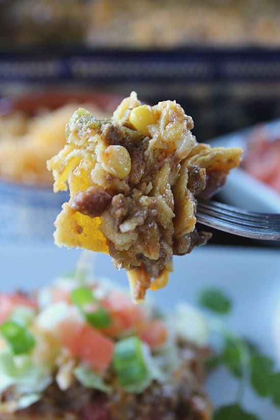  A close up of a bite of taco pie on a fork.