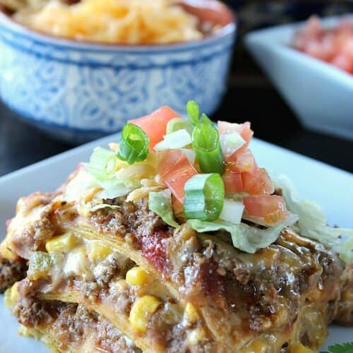 A white plate with a serving of taco pie casserole on it.