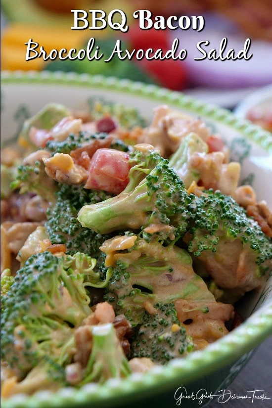 A green and white bowl filled with a serving of broccoli salad.