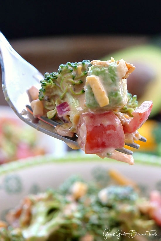 A bite of broccoli salad on a fork.