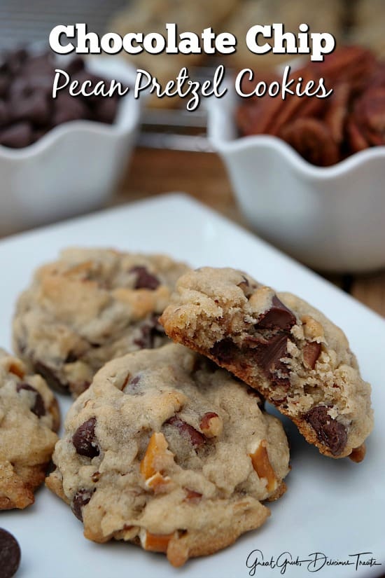 Chocolate Chip Pecan Pretzel Cookies sitting on a white plate with chips and pecans in the background
