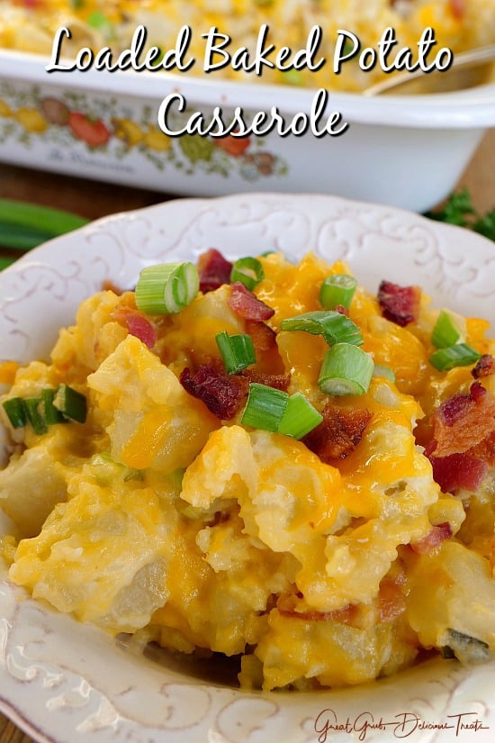 Loaded Baked Potato Casserole - A white bowl full of loaded baked potato casserole with the casserole dish filled in the background.