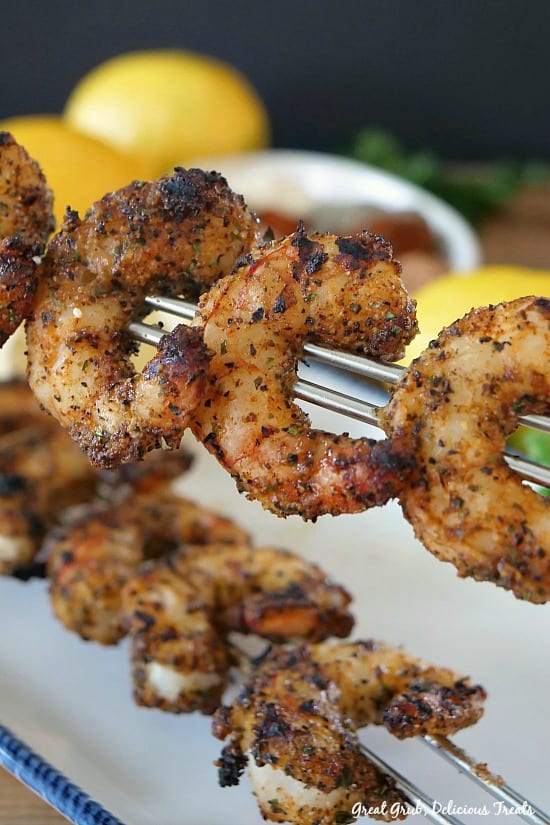Grilled Cajun Lemon Shrimp are barbecued to perfection, seasoned with a dry rub and drizzled with fresh squeezed lemon juice. #delicious #shrimp #cajun #appetizers #partyfood #greatgrubdelicioustreats