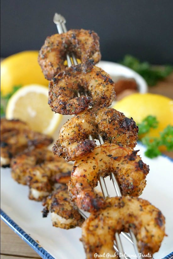 Grilled Cajun Lemon Shrimp are grilled to perfection, drizzled with fresh squeezed lemon juice, and seasoned with a dry rub. #yummy #cajunshrimp #spicy #appetizersideas #barbecue #greatgrubdelicioustreats