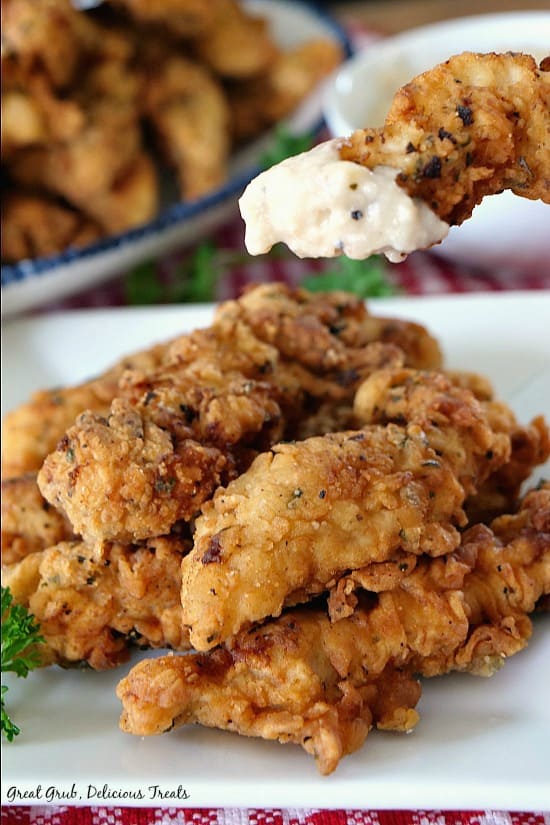 Chicken Fried Pork Fingers are seasoned with the perfect blend of spices and fried to perfection then served with a side of country gravy.