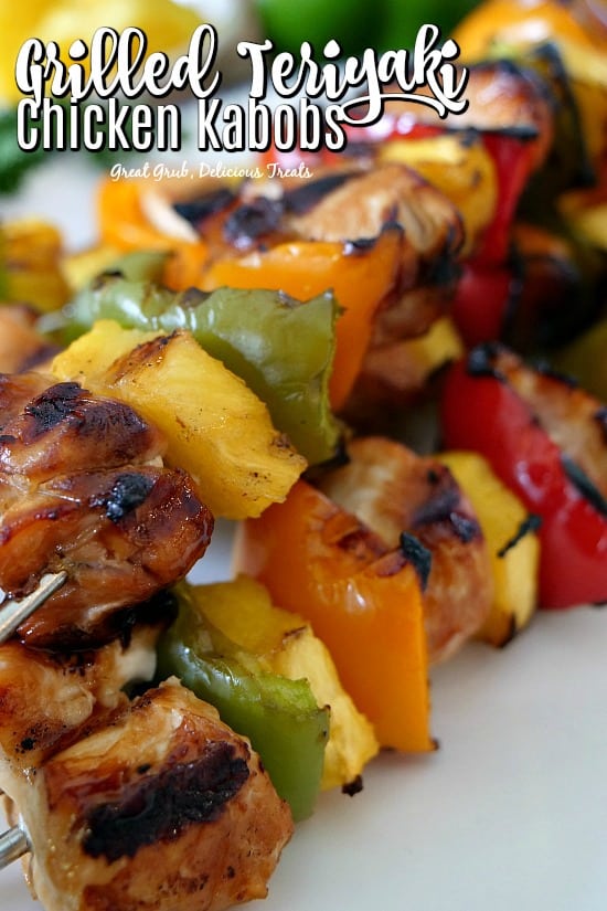 Teriyaki Chicken Kabobs on skewers and place on a white plate after being grilled.