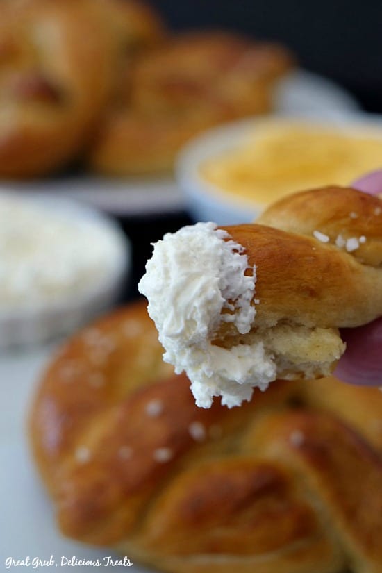 Homemade Soft Pretzels are topped with salt, baked, brushed with melted butter and dipped in whipped cream cheese.