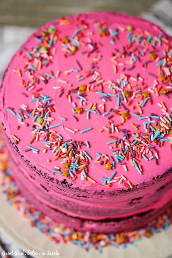 Chocolate Triple Layer Cake is 3 layers of chocolate goodness with pink buttercream frosting.