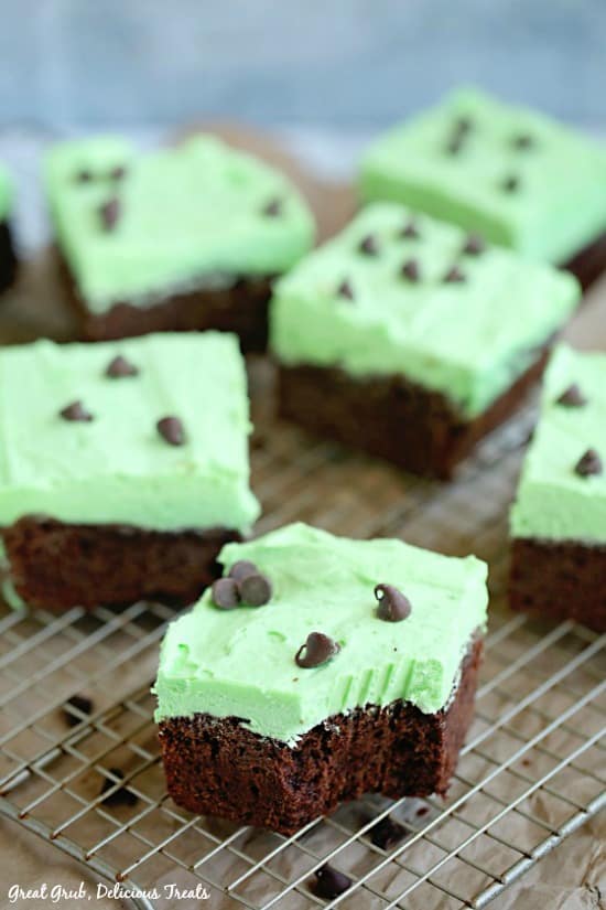 Chocolate Mint Brownies - photo of 6 brownies sitting on a wire rack with a bite taken out of the brownie in front.