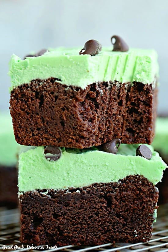 Chocolate Mint Brownies - a photo of two brownies sitting on top of each other with the top one having a bite out of it.