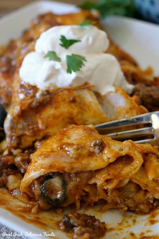Cheesy Ground Beef Enchiladas are delicious and hearty, full of ground beef, two types of cheese and topped with sour cream.