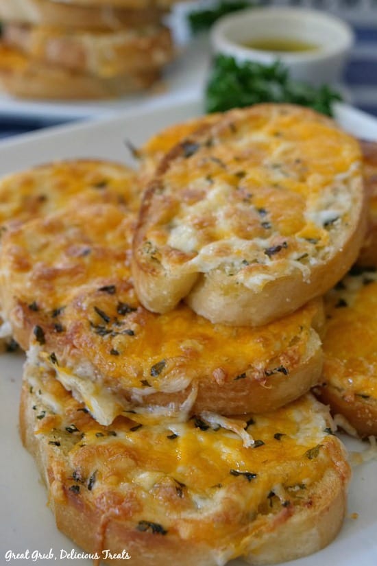 Garlic Cheese Bread is 3 pieces of cheesy garlic bread stacked on each other.