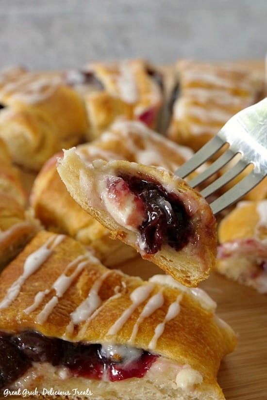 Cherry Cream Cheese Pastry is loaded with a delicious cream cheese filling, cherries and baked and a bite is one a fork.