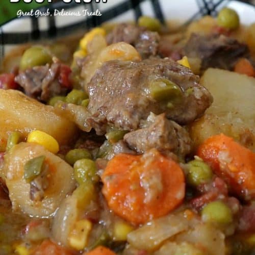 A big bowl of beef stew with hearty vegetables and chunks of beef in it.