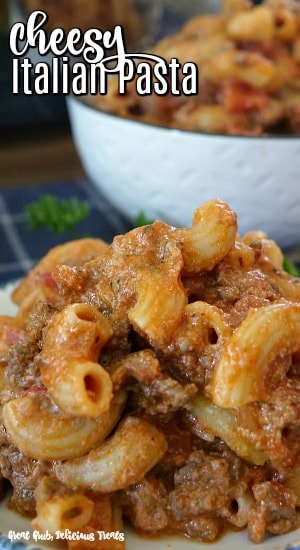 A close up of a serving of cheesy Italian pasta in a white bowl.