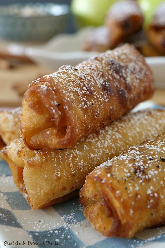 Apple Cream Cheese Egg Rolls - 4 eggs rolls sitting on a blue and white checkered plate.