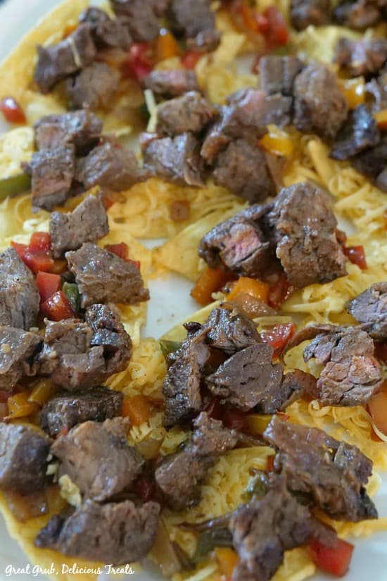 Beef Fajita Nachos - tender pieces of marinated steak in bite size pieces on top of tortilla chips and cheese.