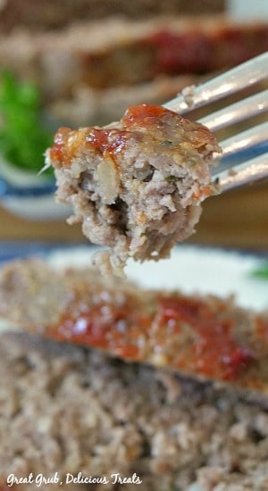 A bite of meatloaf on a fork.