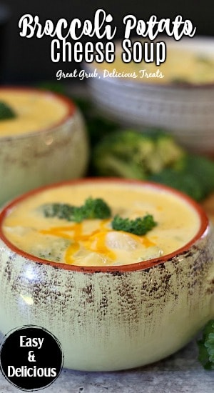 A green bowl filled with a serving of broccoli potato cheese soup.