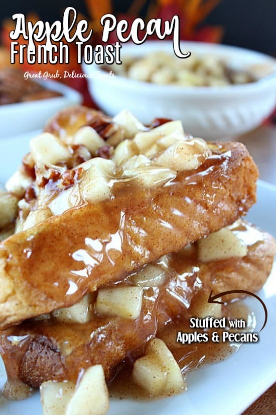 Apple Pecan French Toast - a photo of two French toasts halves on a white plate stuffed with apples and pecans with a bowl of apple filling in the background.