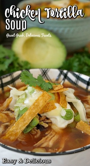 A white and black bowl filled with a serving of chicken tortilla soup.