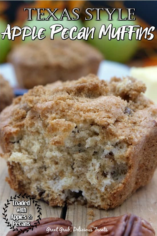 Texas Style Apple Pecan Muffins - a huge muffin with a bite taken out sitting on a cutting board with another muffin and green apples in the background.
