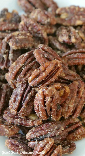 Close up photo of maple candied pecans on a white plate.