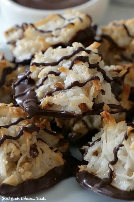 A stack of coconut pecan macaroons piled up on a white plate.