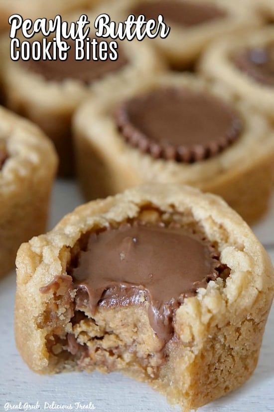 Peanut butter cookie bite in the foreground with a bite taken out, exposing the inside of the Reese's® miniature cup in the center, with peanut butter cookie bites in the background and the title in the top left corner