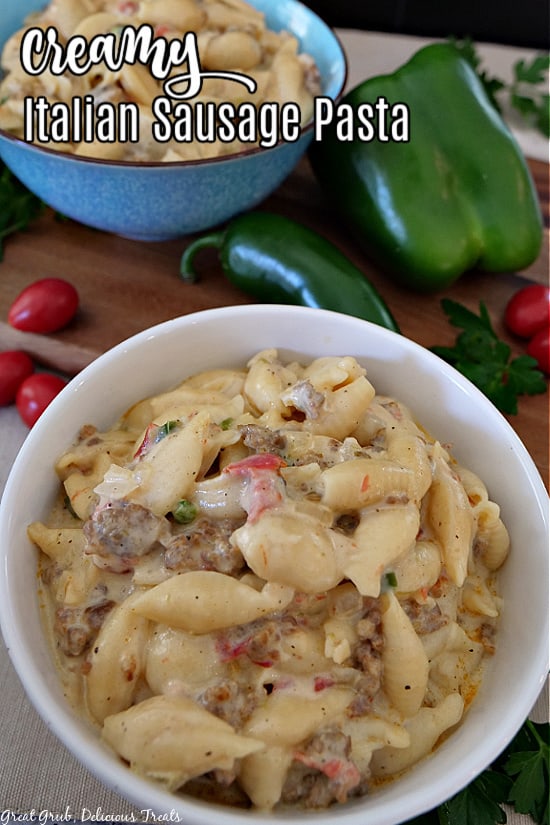 A white bowl and a blue bowl filled with creamy Italian Sausage Pasta.