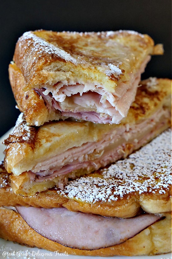 Monte Cristo stacked on top of another Monte Cristo sandwich showing the meat and cheese inside.