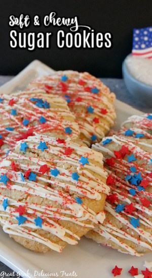 5 decorated with white chocolate, and red, white and blue sprinkles, on a white plate.