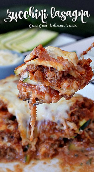 Zucchini Lasagna is a hearty and delicious lasagna recipe made with sliced zucchini in place of the pasta. A bite of zucchini lasagna being held up over a plate of lasagna.