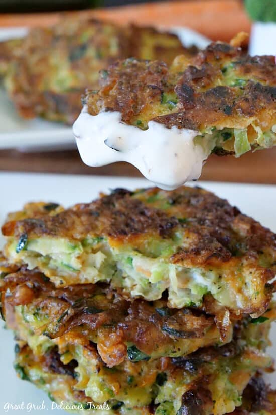 A close up of a vegetable patty after it has been dipped in ranch dressing.
