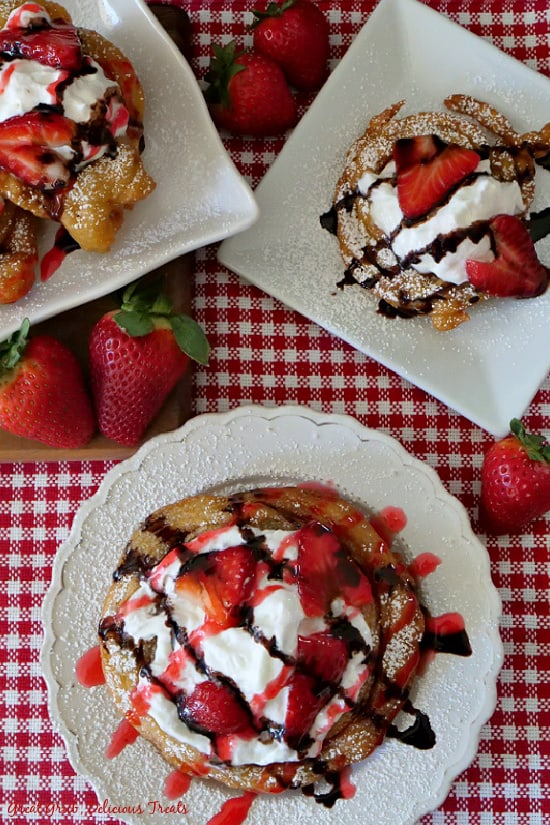 An overhead picture of Strawberry Funnel Cakes on white plate. 