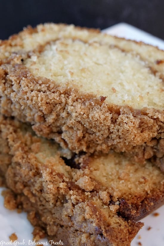 Two slices of cinnamon streusel cake on a white plate.