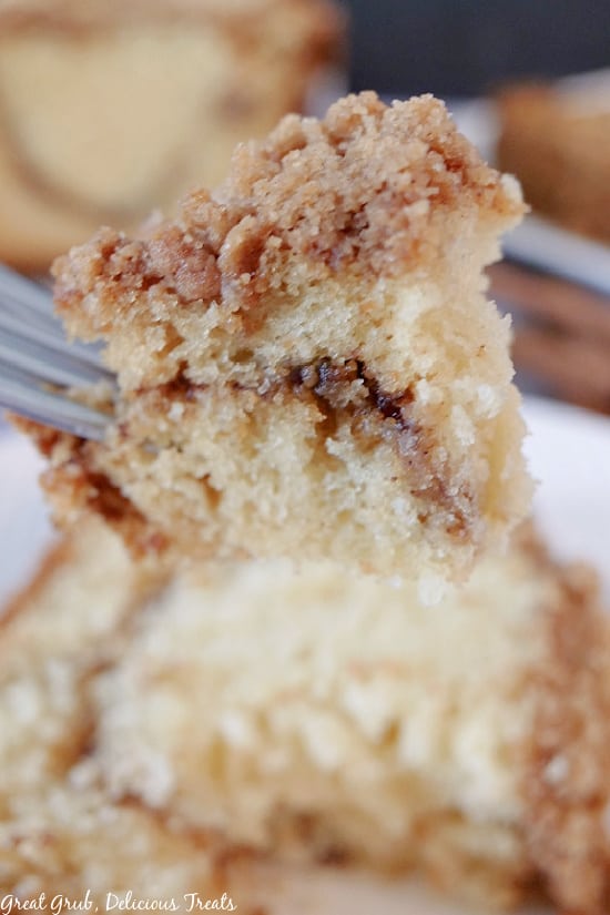 A bite of cinnamon streusel cake on a fork.