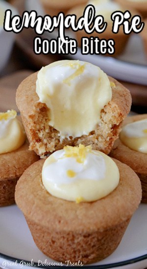 A close up of two mini lemonade pie cookie bites with a bite taken out of one of them.