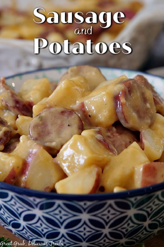 A blue and white bowl filled with sausage and potatoes.