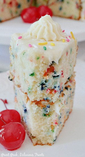 A close up photo of a slice of funfetti cake showing the two layers of the cake. 