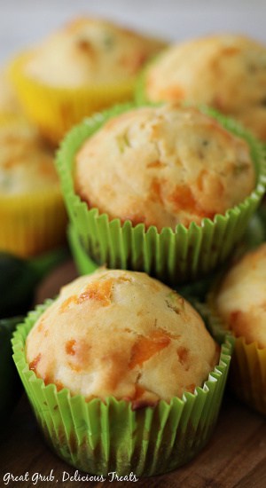 Jalapeno Cheese Muffins in green and yellow muffin liners stacked on top of each other. 