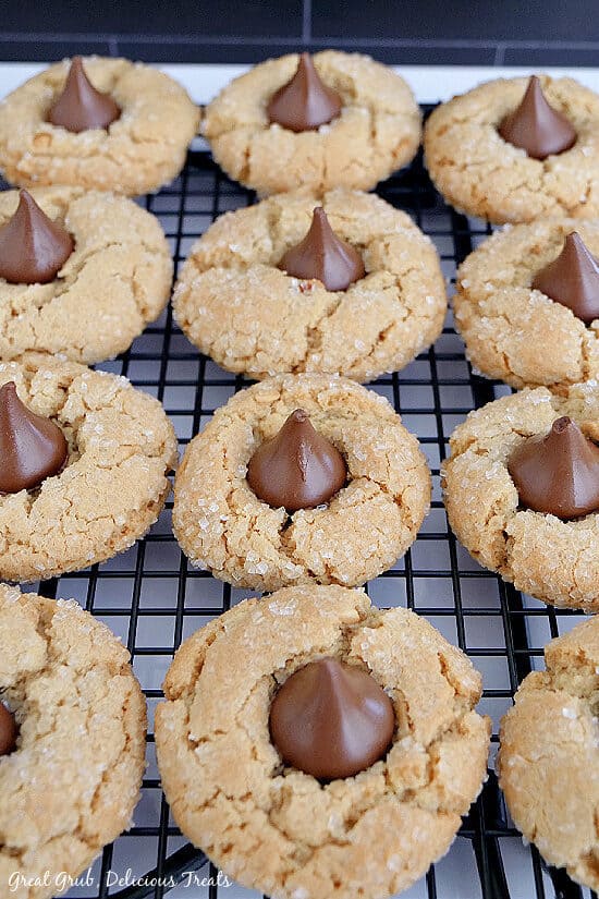 A cooling rack with Peanut Butter Blossom Cookies on it cooling.