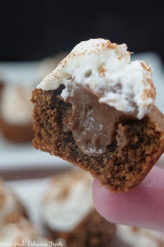 A super close up photo of a Chocolate Cream Pie Cookie Bite with a bite taken out of it.