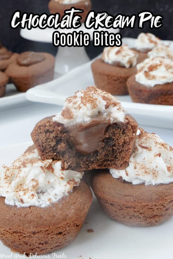A close up photo of 3 Chocolate Cream Pie Cookie Bites with one of them placed on top of the other two and with a bite taken out of it.