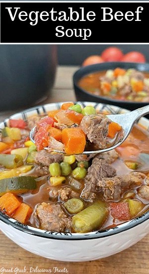 A white and black bowl filled with homemade vegetable beef soup.