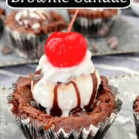 A close up photo of one brownie cup, in a black and white plaid cupcake liner, topped with ice cream, hot fudge, and a cherry.
