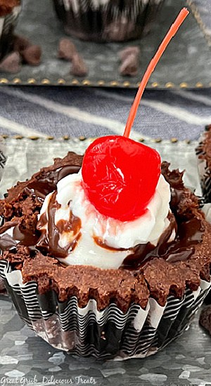 A gooey chocolate brownie filled with vanilla ice cream, hot fudge, and a cherry on top.