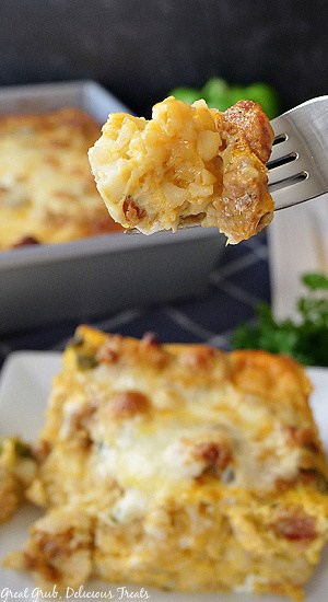 A close up of a bite of sausage and egg breakfast casserole on a fork.