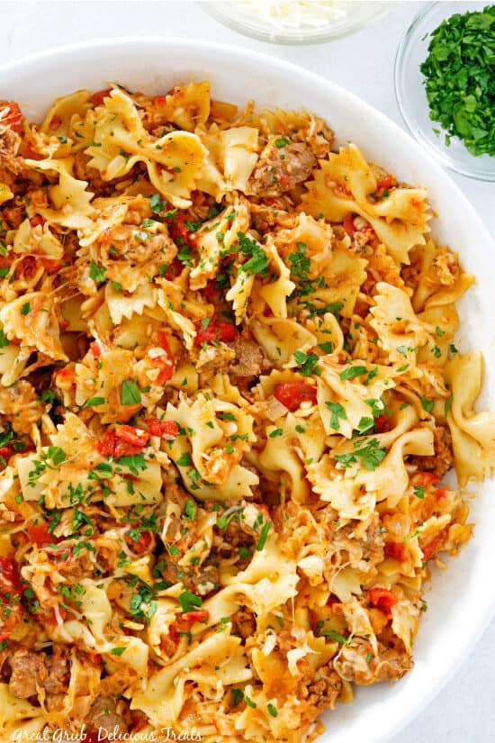 A large white pasta bowl filled with this bowtie sausage pasta recipe.