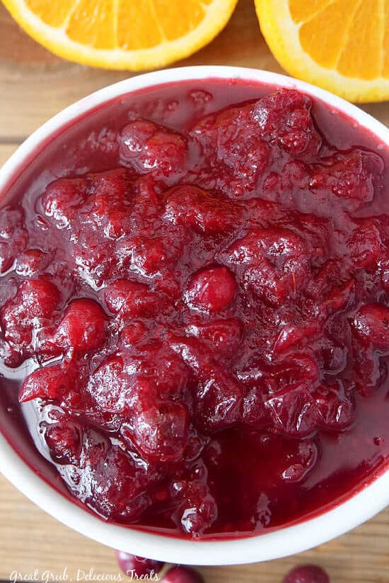 A super close up photo of a white bowl with homemade cranberry sauce in it.